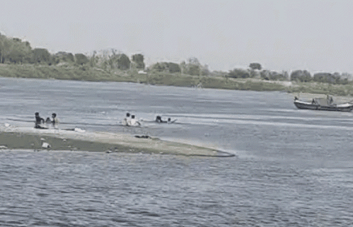 People rescuing by swimming near a riverbank after boat capsized